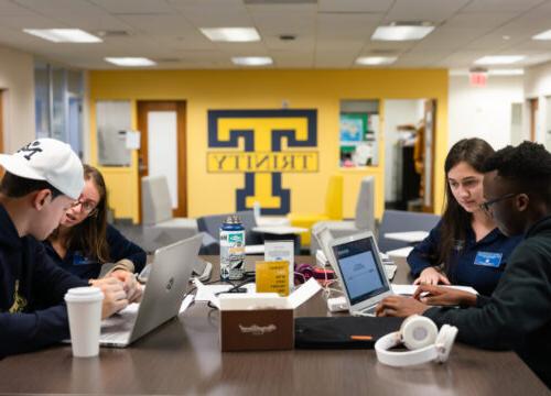 Trinity College students working together at a table